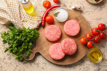 Composition with raw cutlets made of fresh forcemeat on color background