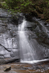 Waterfall, water rushes down beautiful rocks.