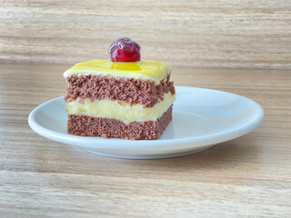 piece of  chocolate cake with cherry on  the white plate    