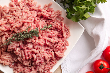 Plate with fresh forcemeat on table, closeup