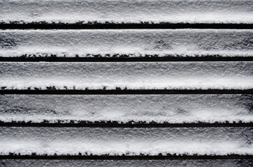 Snow covered wooden fence close up - 448245589