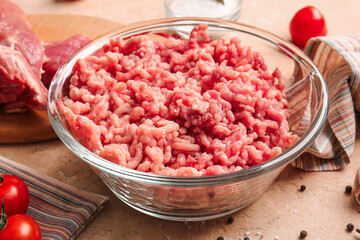 Bowl with fresh forcemeat on light background