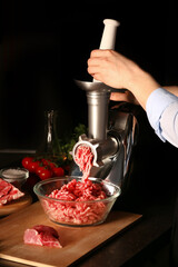Woman preparing fresh forcemeat on dark background, closeup