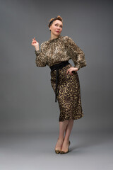full length portrait of a fashionable aged woman isolated on grey