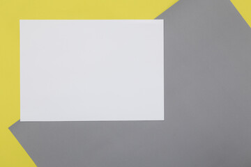 Blank Flyer paper on illuminating yellow and Ultimate Gray pastel paper background.