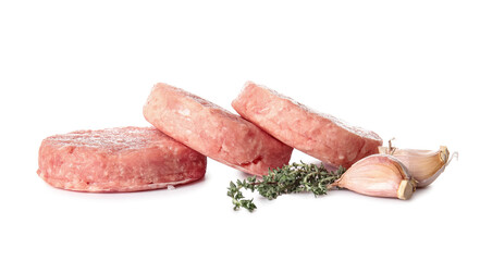 Raw cutlets made of fresh forcemeat and spices on white background