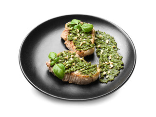 Plate with tasty steaks an pesto sauce on white background