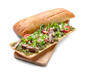 Board with tasty sandwich and pesto sauce on white background