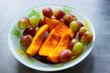 Mango soup with fresh berries and fruits.