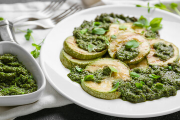 Plate with grilled zucchini and pesto sauce, closeup