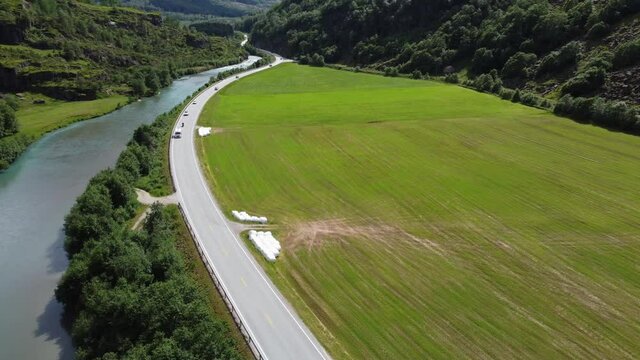 E39 Higway through stardalen valley between Byrkjelo and Klakegg in Sogn Norway - Aerial showing road in bottom of valley with summer traffic and the stardalen river close by
