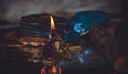 Candle burns on the altar, magic among candles, clean negative energy, wicca concept - obrazy, fototapety, plakaty