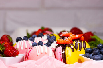 Macaroon, Handmade Beautiful Sweet food, Dessert with fresh strawberries and blueberries decorated with chocolate, Delicate yellow and pink cakes, Sweet and healthy food