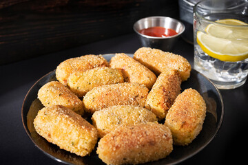 Typical croquettes of Spanish cuisine. Traditional tapas of Spanish cuisine. Tapas plate with croquettes with dark background
