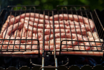 Sausages in lamb intestines are fried on the grill.