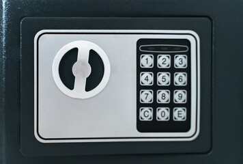 Black small home or hotel safe with keypad.