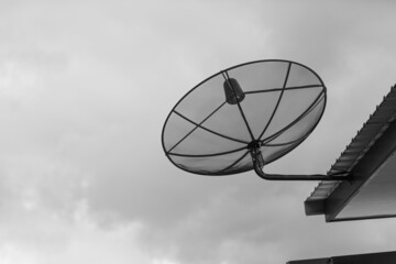 Satellite dishes are installed on the roofs of houses