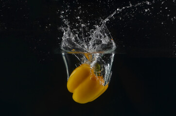 yellow pepper on black background