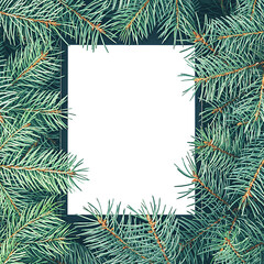 Fototapeta na wymiar Creative Christmas layout made of spruce branches with a white tablet screen. Christmas background. Flat lay.