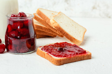 Tasty sandwich with cherry jam on light background, closeup