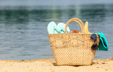 Bag with beach accessories on sea coast