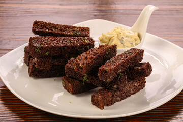 Tasty garlic croutons with sauce