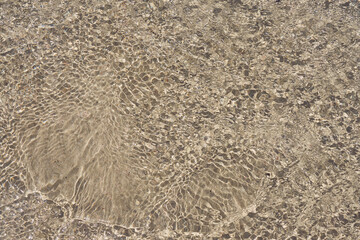 Surface of clear water on tropical sandy beach in Crete Greece.
