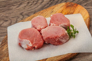 Raw pork medallion served rosemary