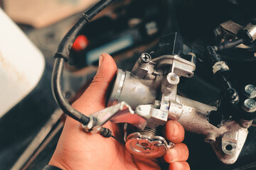 Injectors of motorcycle engines checked by a mechanic.