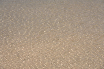 Surface of clear water on tropical sandy beach in Crete Greece.