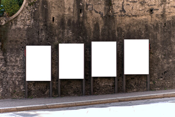 four blank, white, vertical billboard in Lugano Switzerland 