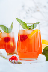 Cold drink. Orange drink with mint and fruits. Fresh drink in glass. Summer drink. Drink from beach...