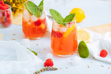 Cold drink. Orange drink with mint and fruits. Fresh drink in glass. Summer drink. Drink from beach bar. - obrazy, fototapety, plakaty