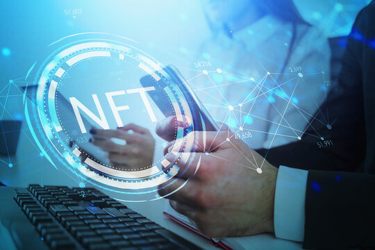 Businessman and businesswoman browse the Internet using digital devices, non-fungible token hologram, nft with network circuit and globe. Concept of cryptocurrency art and technology