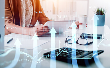 Businesswoman or stock trader analyzing stock graph chart using tablet device with touchscreen to buy or sell stock, forex bar charts, internet trading concept
