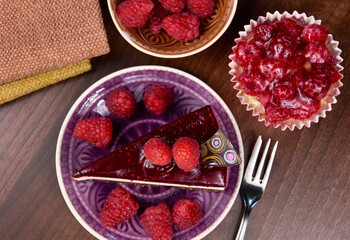 Delicious creamy raspberry cake on the table top view stock images. Slice of cheesecake with jelly topping and raspberries still life stock photo. Raspberry desserts images