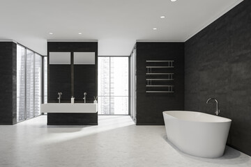 Fototapeta na wymiar Black-and-white bathroom with panoramic windows, partition, towel rack and white tub