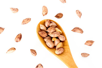 Roasted peanuts in a wooden spoon.