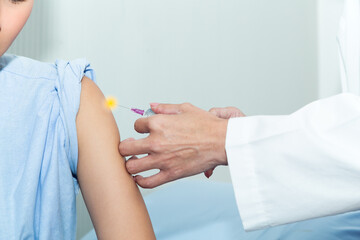 Doctor giving patient vaccine, COVID-19, flu or influenza shot. Vaccination and prevention against flu, Covid-19 virus pandemic with syringe at hospital room.