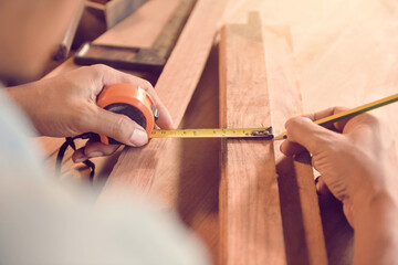 Carpenters using circular saw in workshop