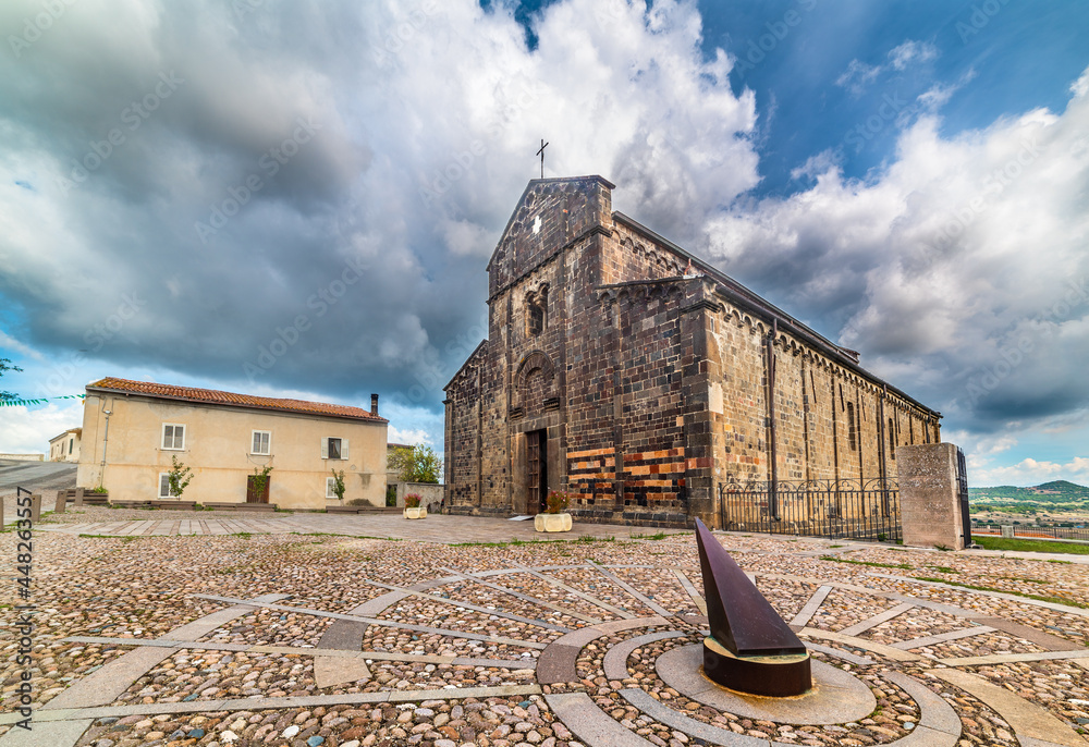 Wall mural Sundial in Santa Maria del Regno square in Ardara on a cloudy day.