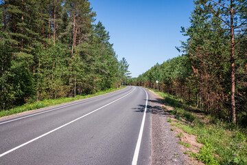 Fototapeta na wymiar Picturesque asphalt road, beautiful summer view, Leningrad region, Russia