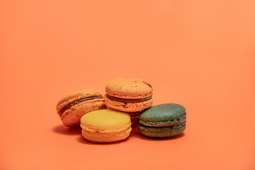 Close up of macaroons on an orange background