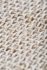 Natural burlap fabric with fibers as background.