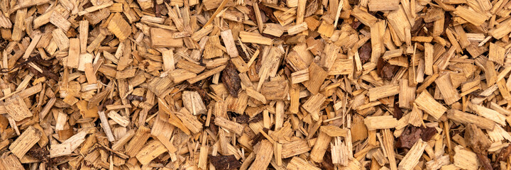 Panoramic background. Bark mulch, brown wood chips
