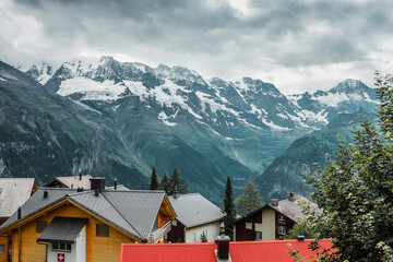 Fototapeta na wymiar Roofs of traditional chalet in Swiss Alps. Switzerland, Jungfrau. Cozy small village in mountains. Beautiful landscape, Europe.