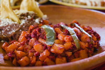 Papas with chorizo or potatoes with chorizo and refried beans, mexican food in Mexico City