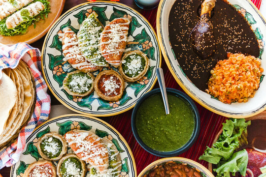 Traditional mexican dishes sopes, tacos dorados, tortillas, mole poblano, red rice, rajas poblanas, beans, pipian, salsa verde in Mexico City
