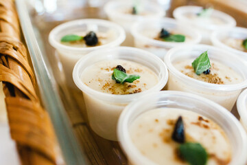 Cremitas traditional mexican pudding vanilla cream sprinkled with cinnamon and raisin, typical mexican desserts in Mexico