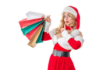 Mrs. Santa Claus smiling happily. Pretty woman in red dress, white fur. Cheerful girl in Santa’s hat.